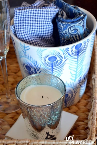 When we have guests, I can pull down the wicker basket which holds some adorable blue cloth napkins, this great-smelling candle and our champagne flutes. 