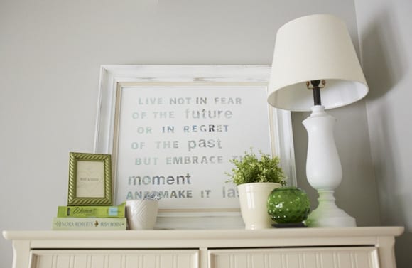 The green decor accents pair well with the neutral, white tones. 