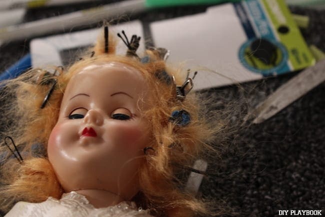 A creepy doll with hair pins and clips all over!
