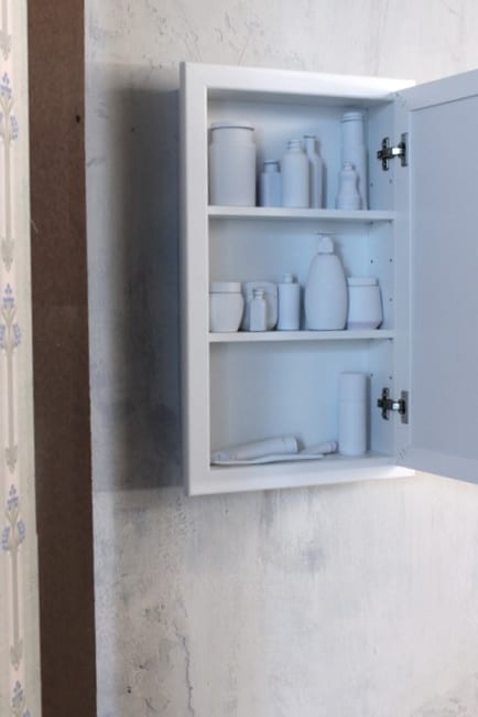 A basic medicine cabinet filled with white toiletries. 