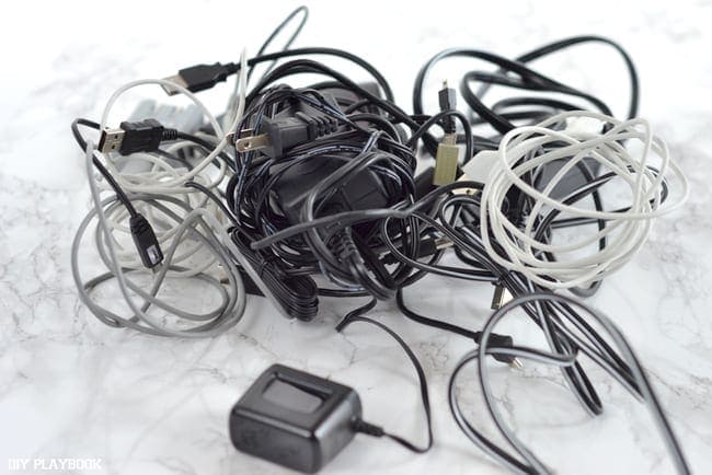 A big mess of tangled electronic cords. 