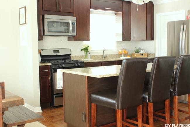 These dark kitchen bar chairs pair well with the dark wood cabinets. 
