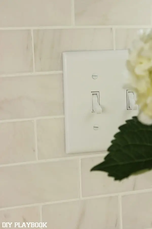 The white light switches pair well with the new kitchen backsplash.