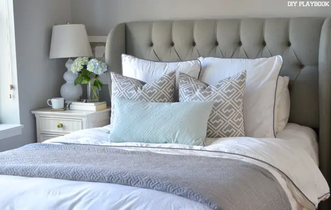 The neutral tones in this bedding pair well with the gray walls.