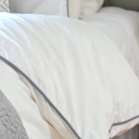 The gray piping on the duvet cover adds a beautiful detail.