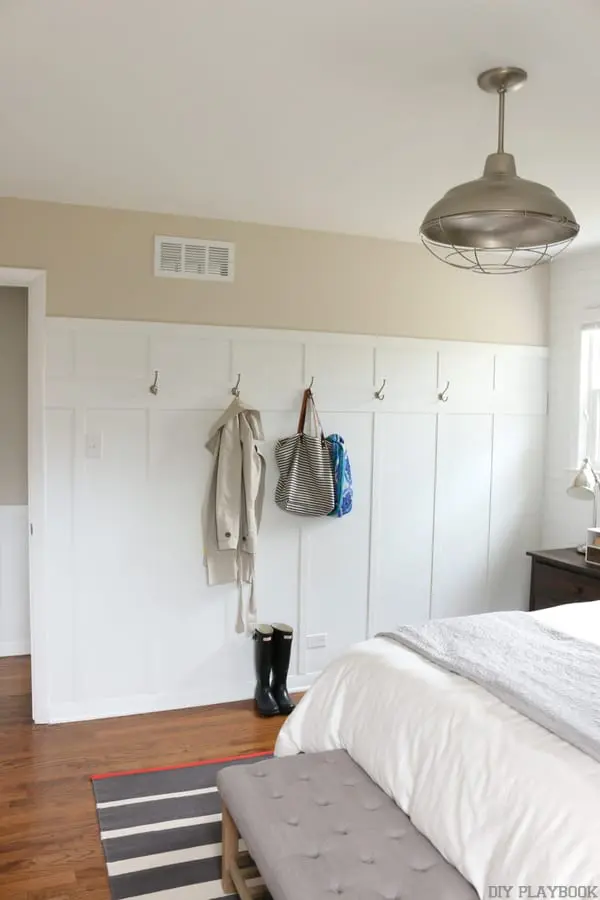 The board and batten bedroom wall adds charm to the space. 