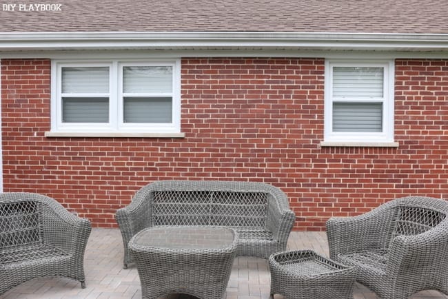 This outside brick wall is bare and needs decor. 