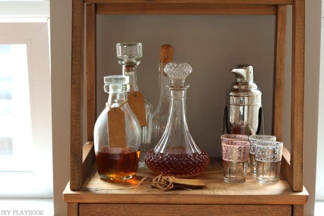 A cute bar shelf with a crystal decanter is a great living room accent. 