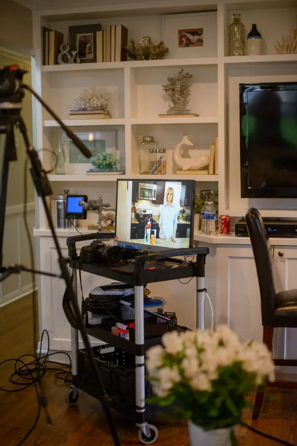 A behind the scenes look of cameras filming Casey as she's in her kitchen. 