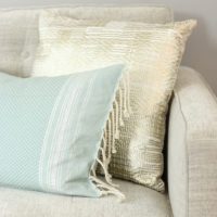 Soft colored throw pillows look beautiful on a greige couch.