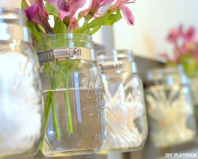 The versatile mason jar organizer can hold flowers and other bathroom essentials. 