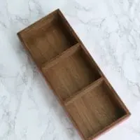 Divided wooden tray for office supplies like paper clips and push pins