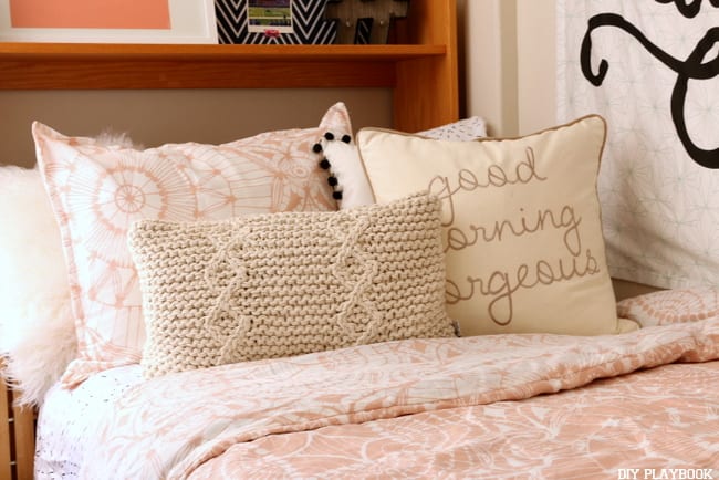 The adorable bed spread and accent pillows look great in the dorm room. 