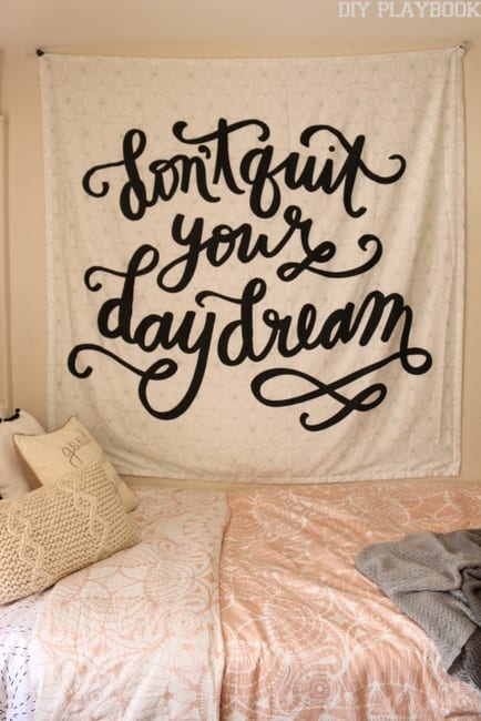The cute tapestry adds wall decor to the dorm room.