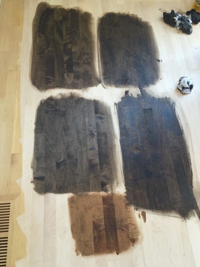 Testing hardwood stain color choices for our floor makeover. 