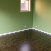 Master bedroom with new darker floors but bright green walls.