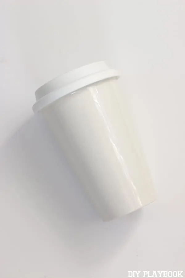 Start with a plain white ceramic travel coffee mug. You can get these from any home store or craft store. 