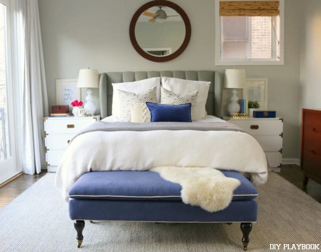 Master bedroom makeover with grey walls, white and bright blue accents. 
