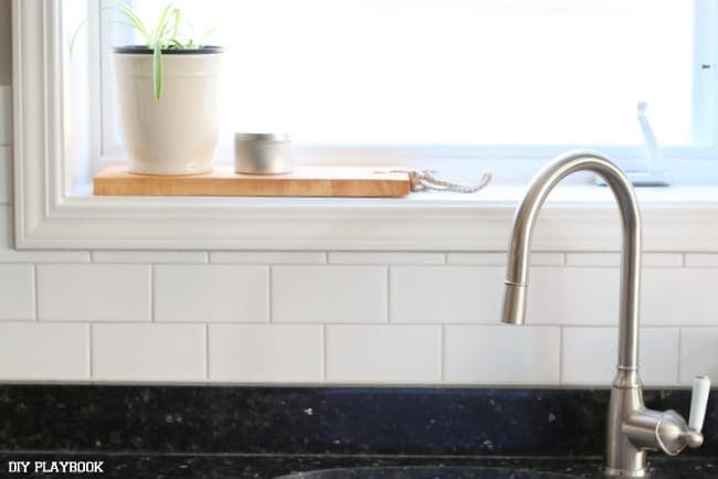 The White Subway Tile Backsplash makes such a dramatic difference and works so well with our existing kitchen sink. 