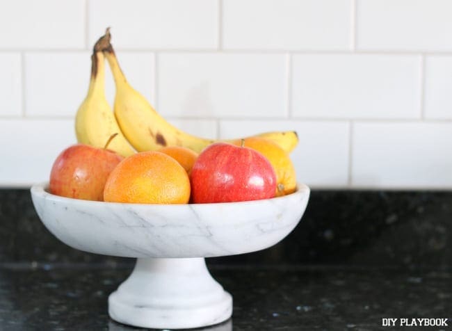 This marble fruit bowl looks great with the granite counter tops. 