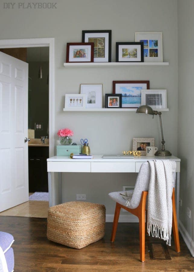 Corner office in a small bedroom with bright white desk. 