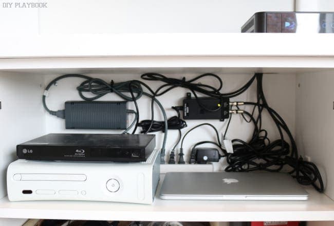 We store all the electronics for our TV and cable in this cabinet in our built in. | DIY Playbook