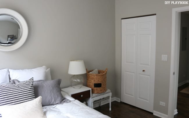 The guest room closet doors contrast well with the other white furniture in the space.