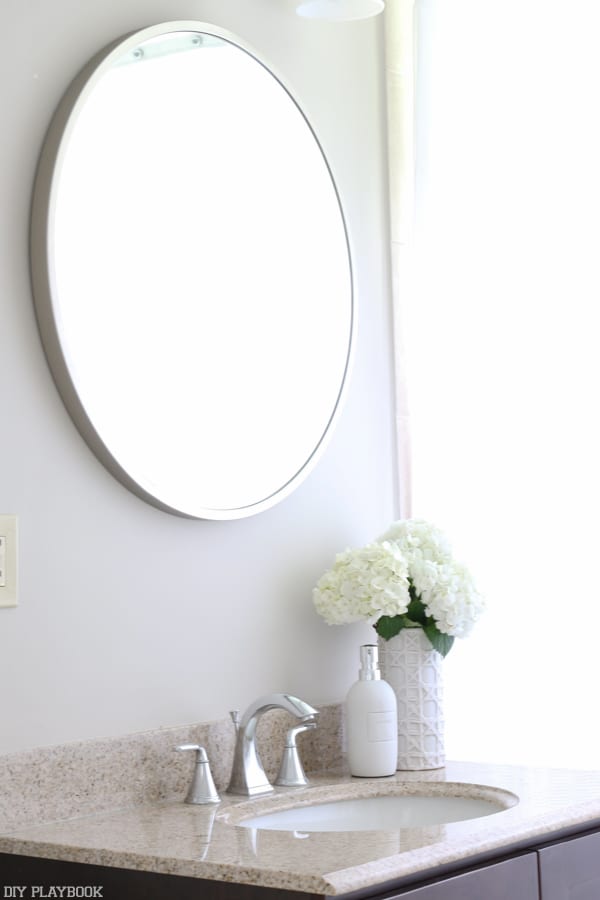 A silver round mirror from West Elm
