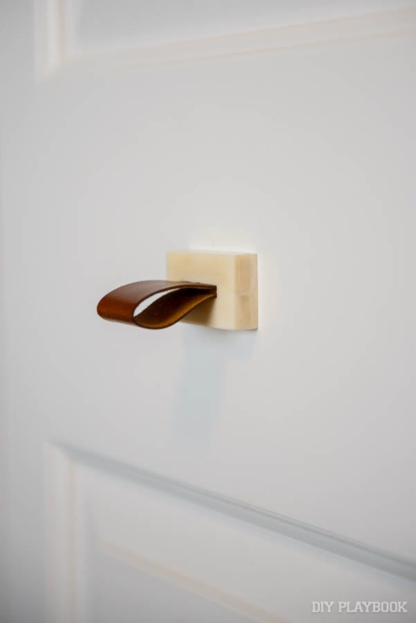 This leather closet door pull is functional and decorative. 