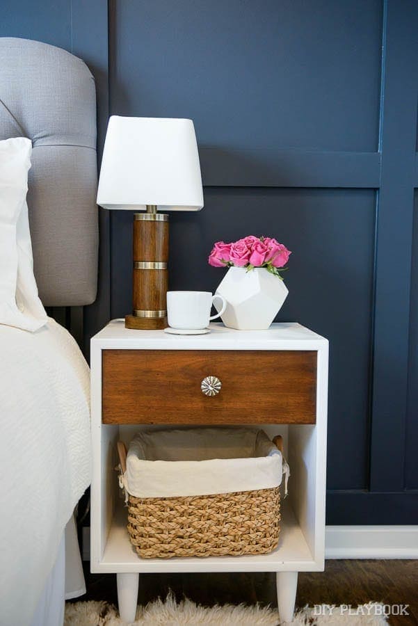 The wood accents pair well with this white nightstand. 