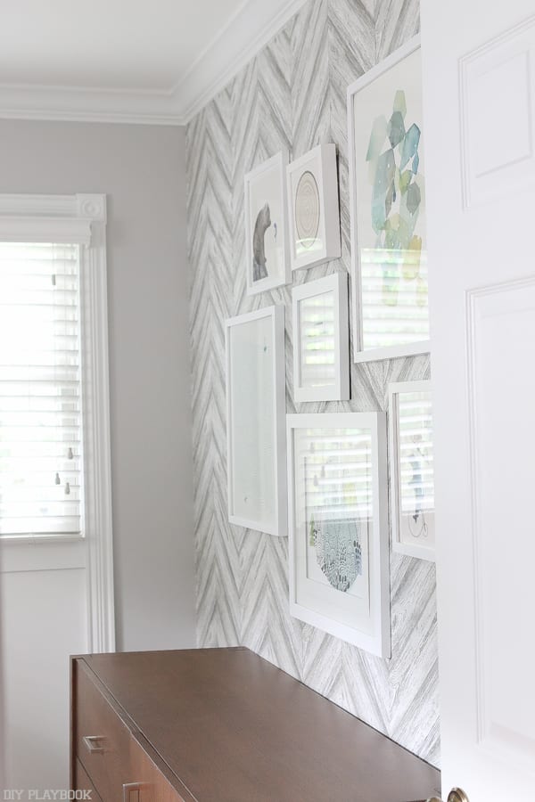 Hanging frames against the temporary wallpaper adds more decor. 