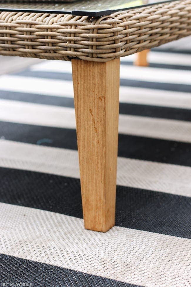 Aren't the wooden legs on our wicker coffee table great? I love how it all looks with the classic striped rug.