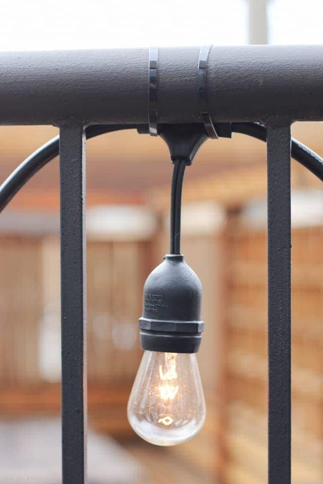 We attached these little lights with zip ties, and they add so much to the romance of the balcony space!
