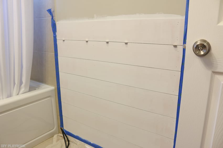 Hang the pieces of shiplap on the wall by nailing them in until secure. 