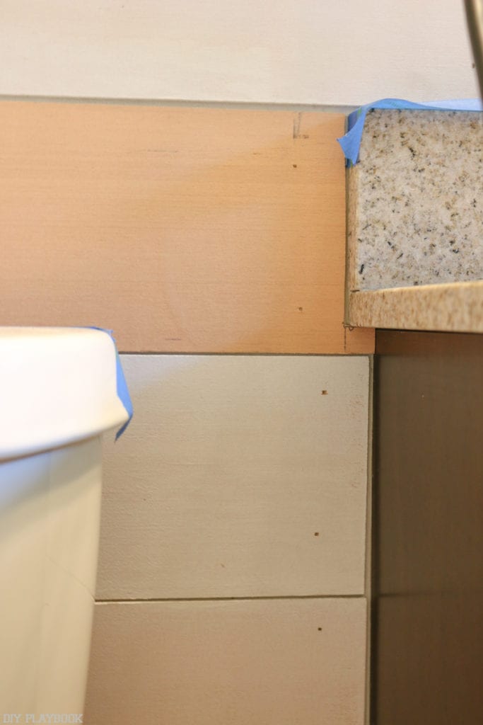 Making small cuts in the shiplap makes it easier to hang pieces around the vanity. 