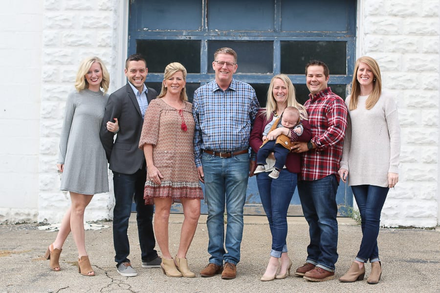 Outfits that are cohesive is an important part of taking a family picture. 