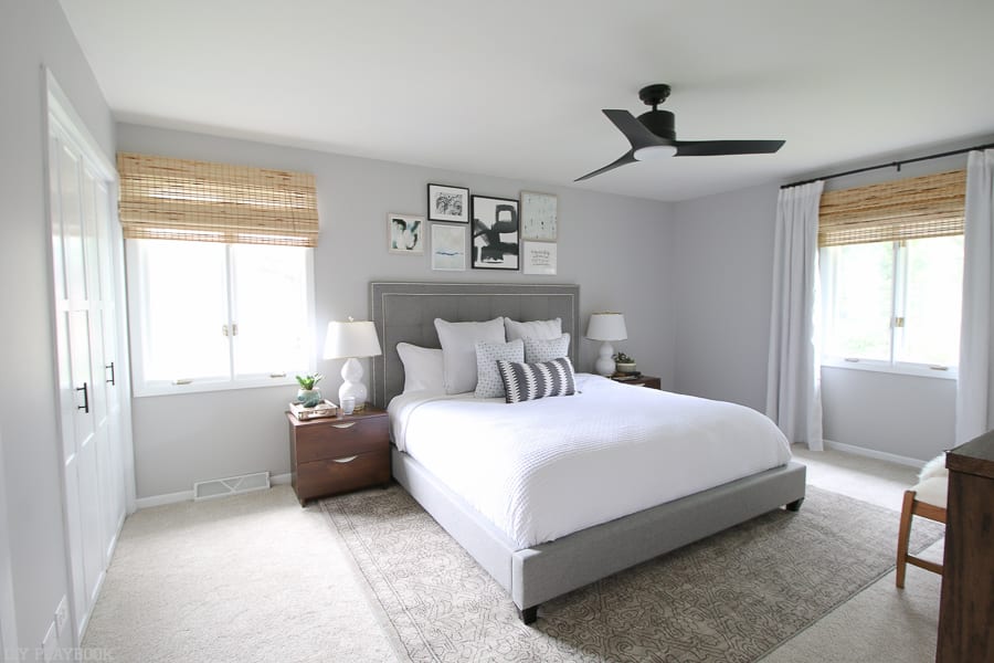A neutral bedroom with a contemporary ceiling fans