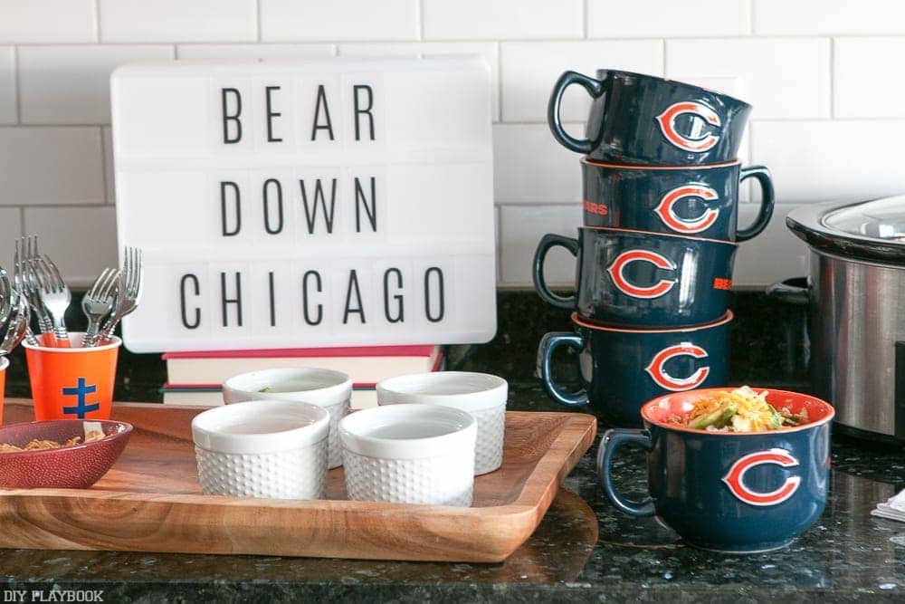 Here's our chili set up for our football watch party! Fun signage, team-themed mugs and delicious chili all make for a great party!