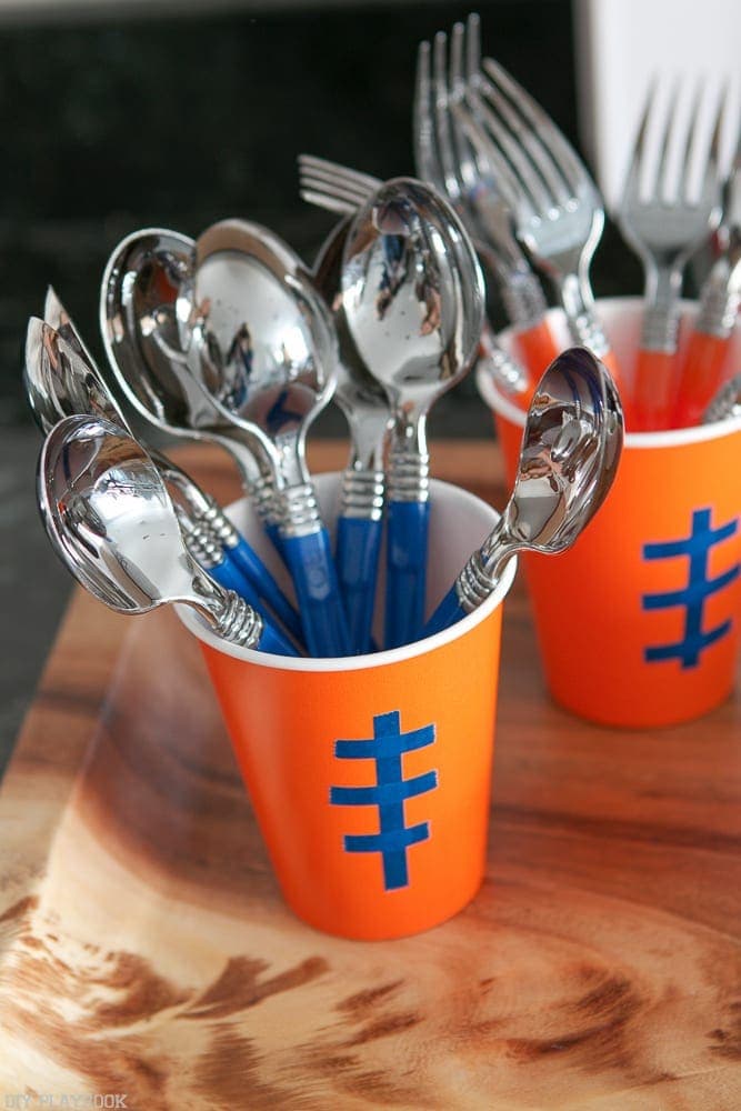 We DIY'd these adorable orange plastic cups to look like little footballs, and to act as holders for our disposable silverware! 