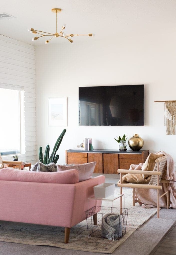 Some small decor pieces around the TV would add more visual interest to the living room.