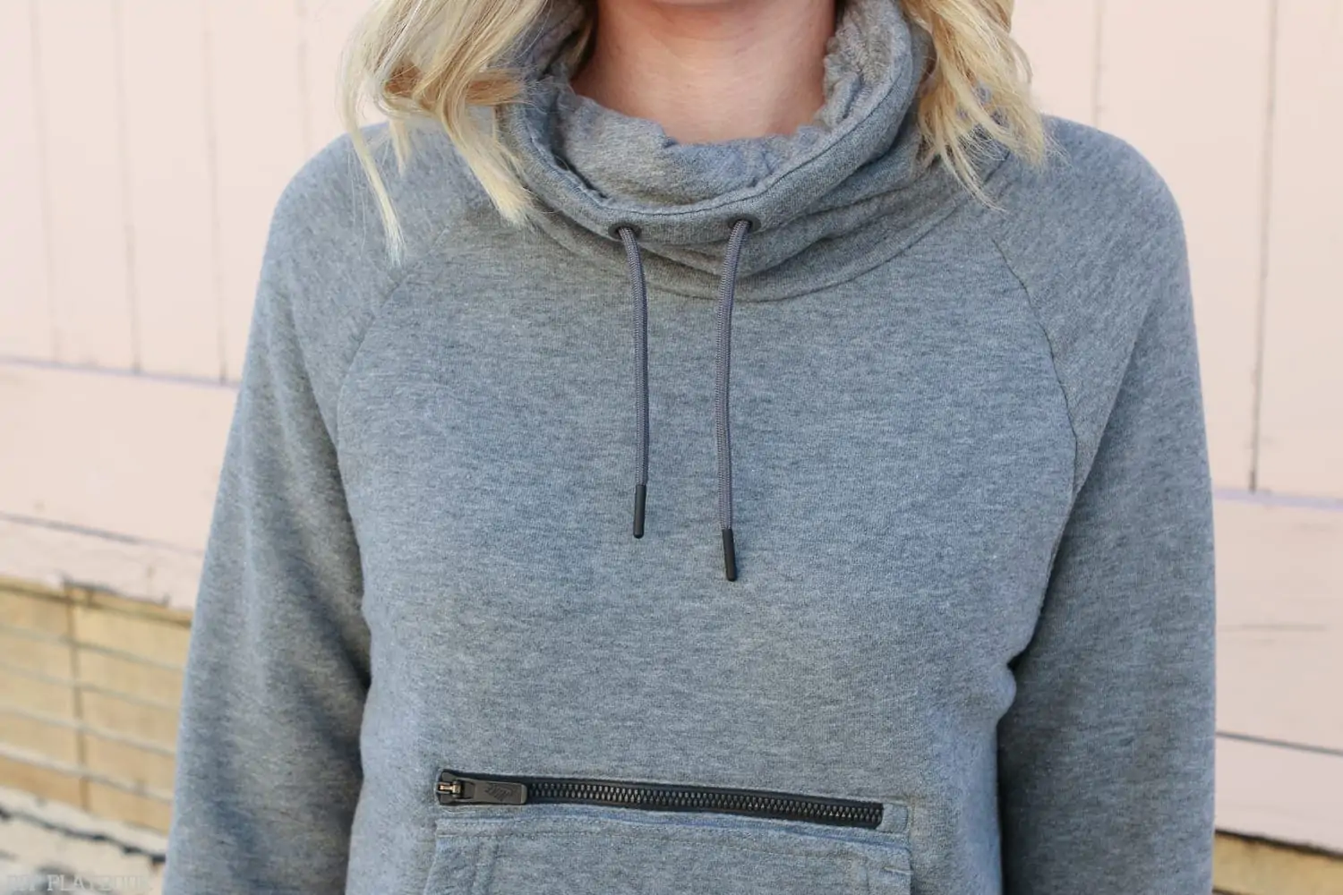 One of Bridget's fav Athleisure Pieces to Wear Anytime is her cowl neck hoodie with a giant front pocket. 