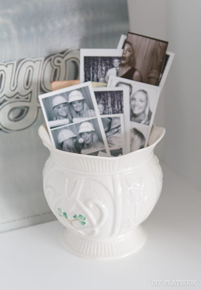 Photo booth strips displayed in a vase