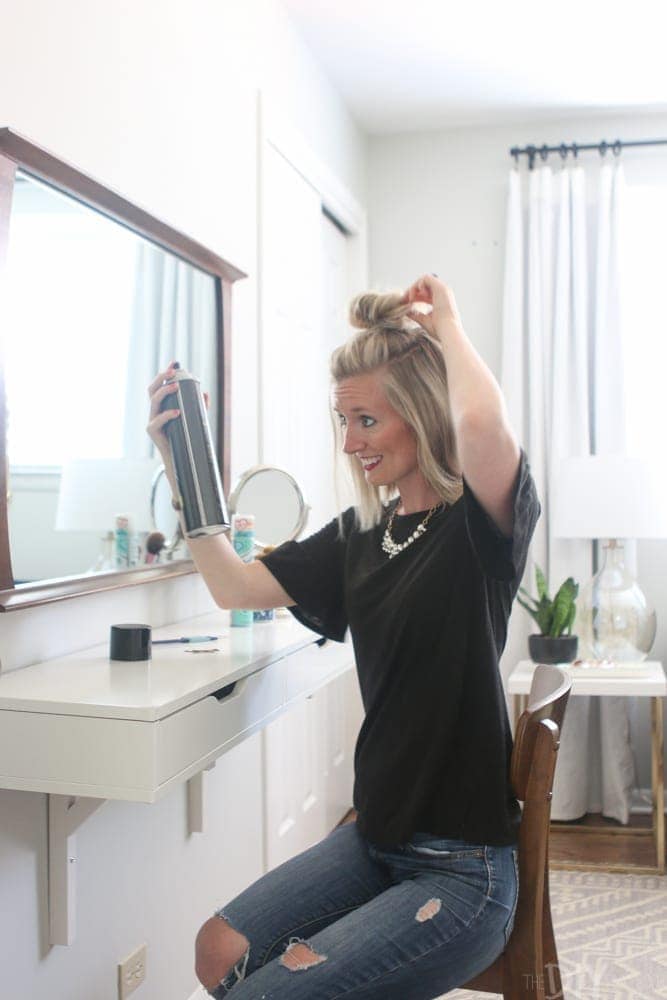 How_to_put_your_hair_in_a_topknot-spraying