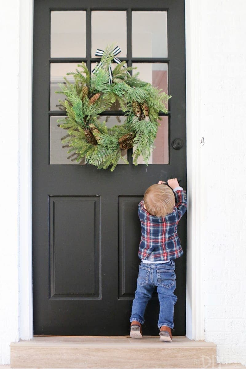 Fall front door design with a simple evergreen pine wreath. 