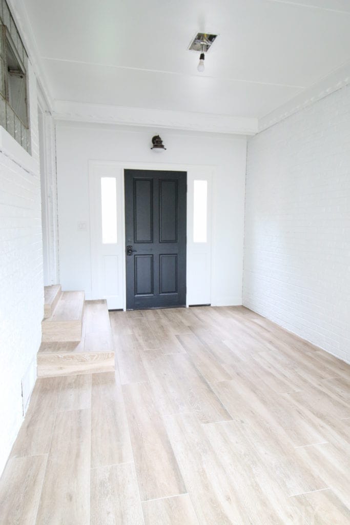 A black and white mudroom in need of functional storage