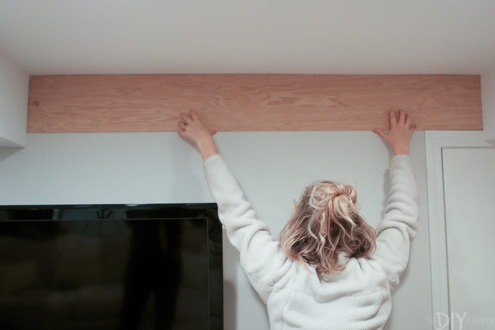 FInd out how to install a shiplap wall - even with a TV in the way! Here we are laying out the first boards. 