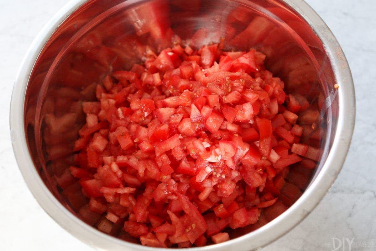 Chopped tomatoes in a large bowl to be used for a pasta recipe. 