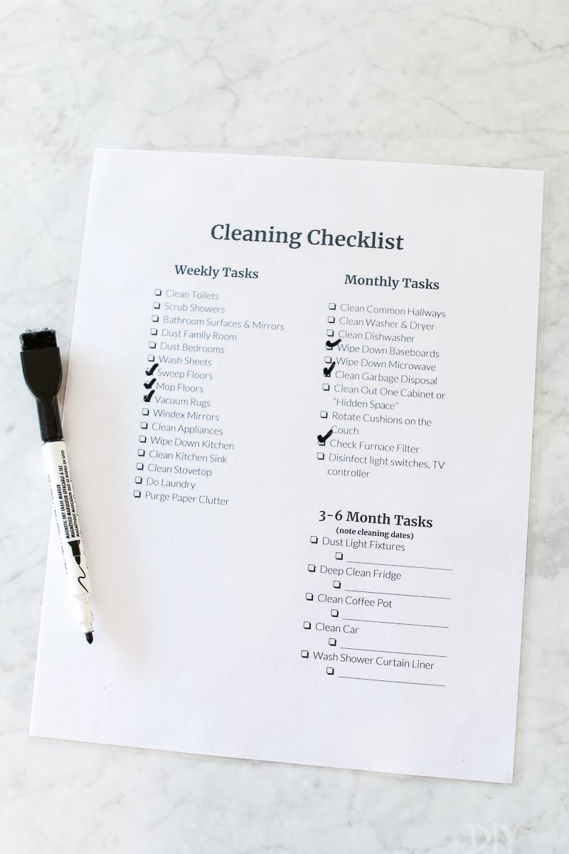 Crossing off cleaning tasks on my cleaning checklist