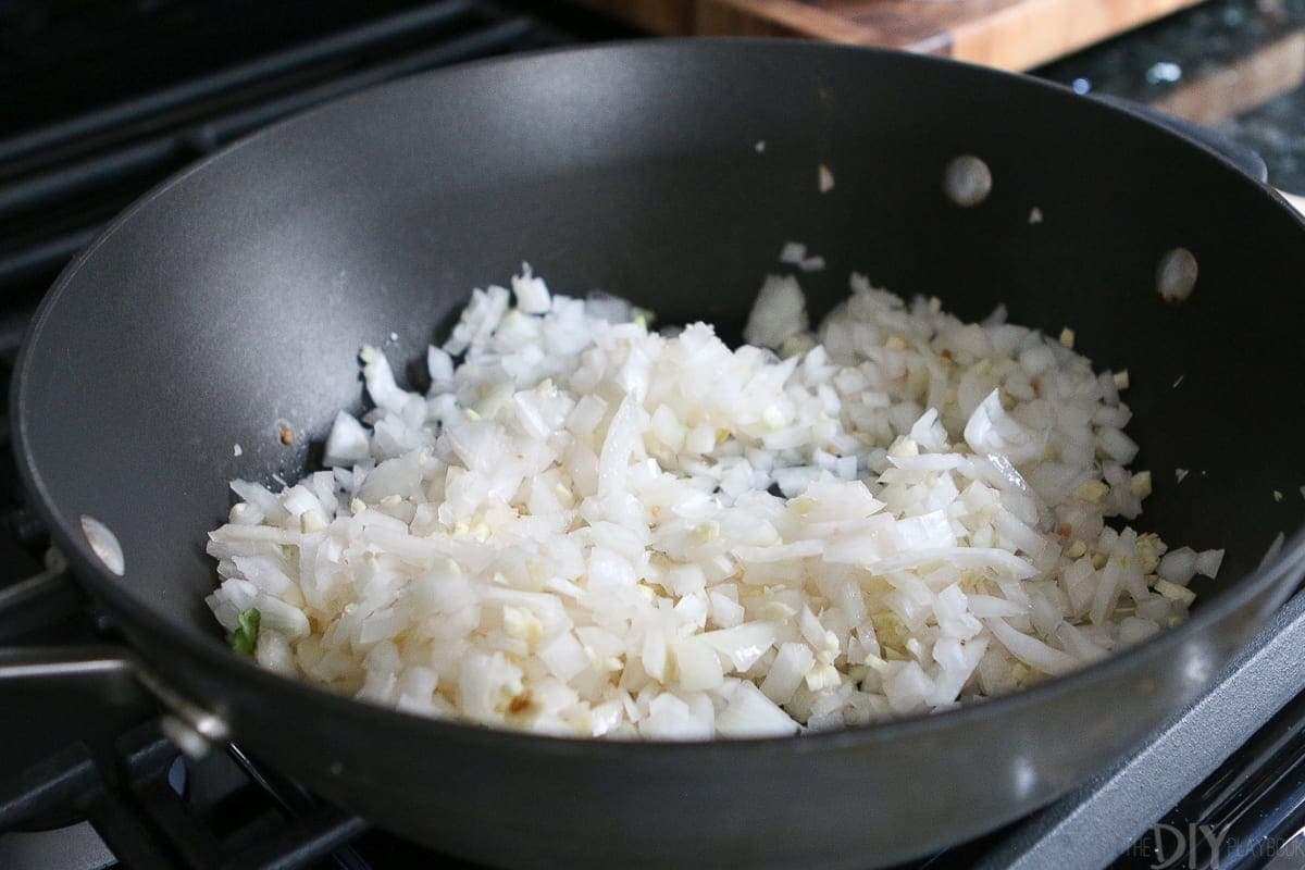 Saute garlic and onions in a large skillet on the stove. 