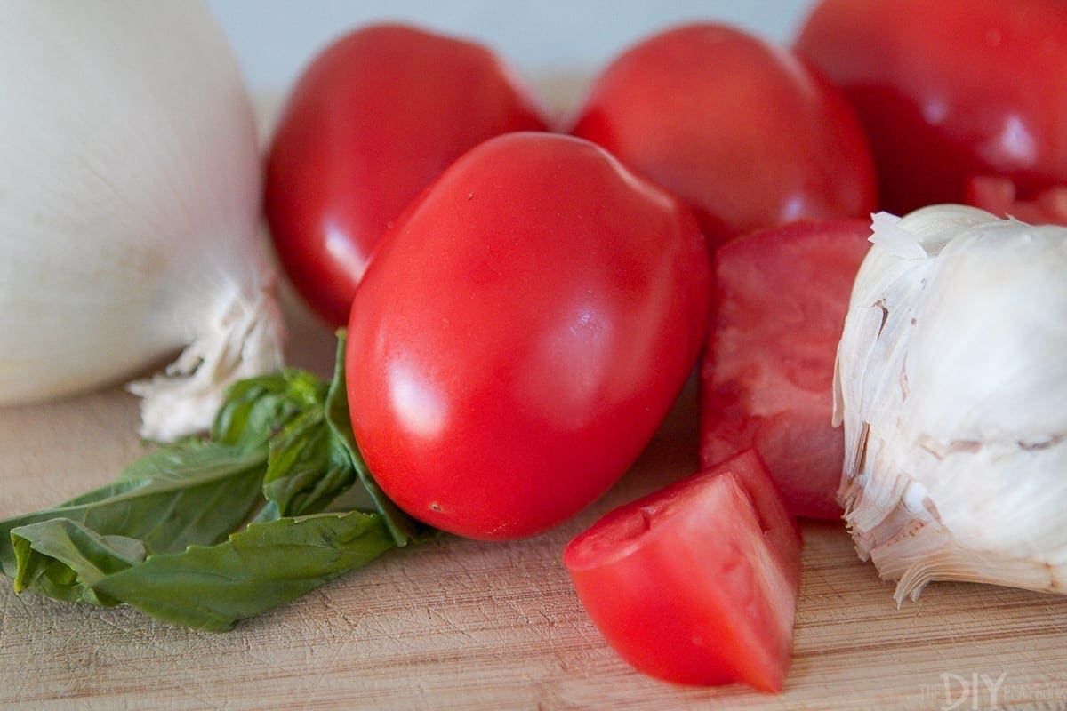 Fresh tomatoes, garlic, basil, and onions for a pasta recipe. 